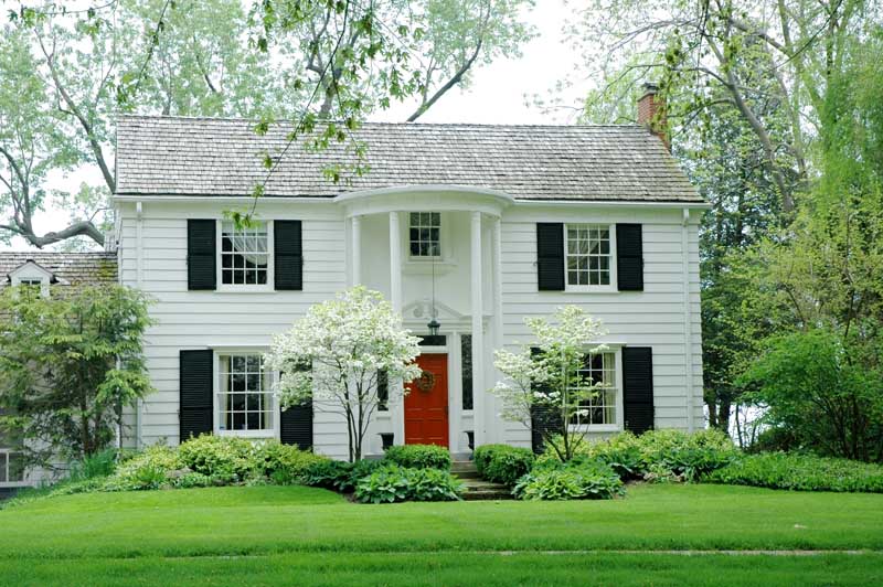 Exterior black shutters on a white house.