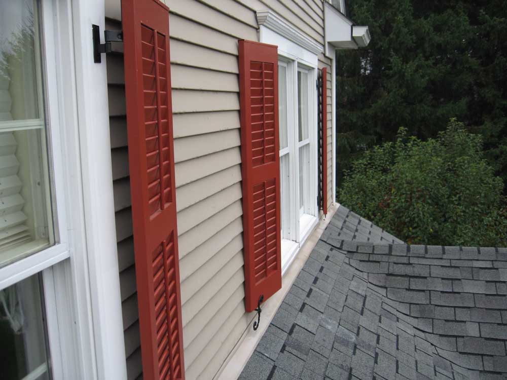 Functional outdoor shutters with exterior hardware.