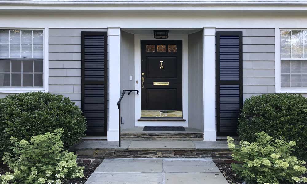 Tall front door exterior wood shutters for the outside entry.