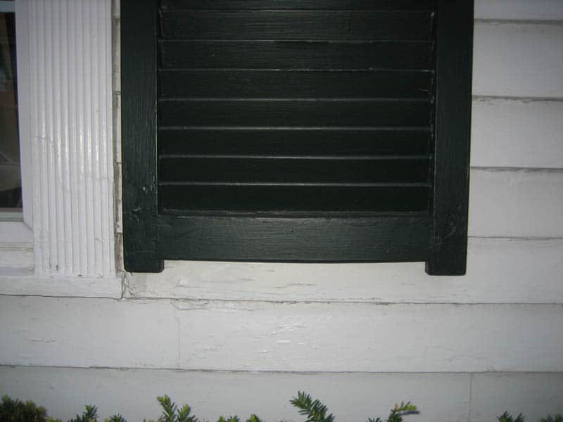 Wood exterior shutters with tails and horns.