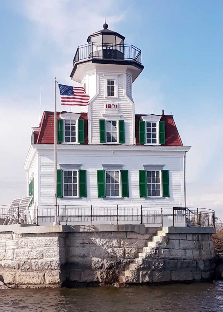 Green exterior weather-resistant shutters installed on a lighthouse in the Hudson River.