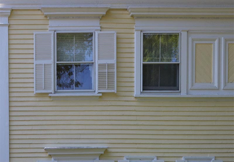 Exterior shutter tails on a yellow house.