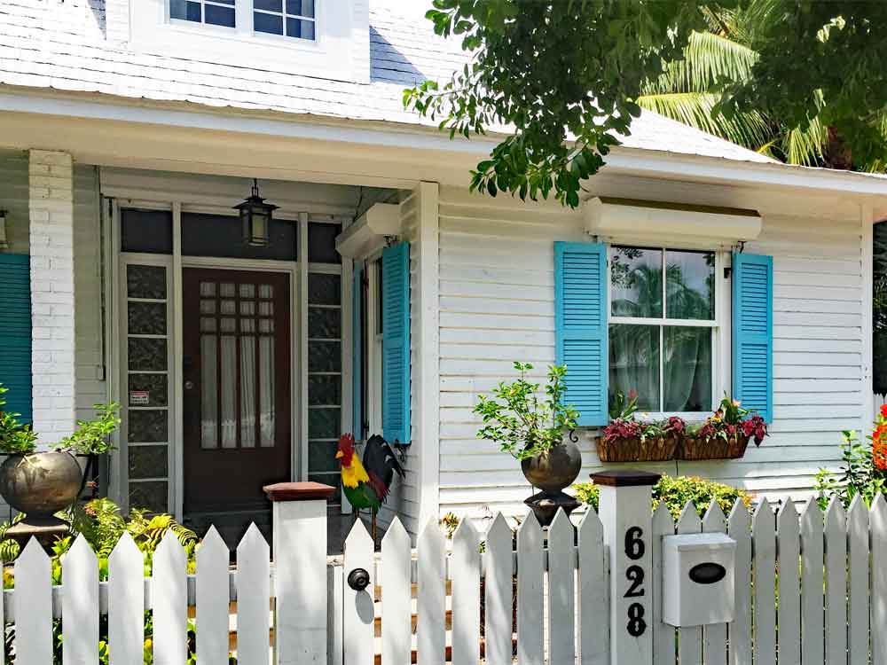 Colorful turquoise key west exterior shutters.