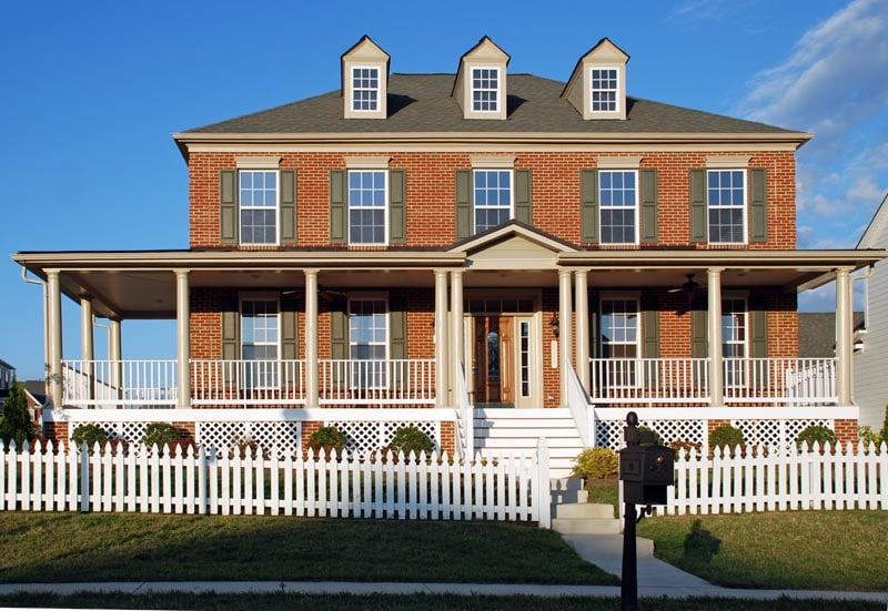 Raised panel exterior vinyl shutters installed on brick.