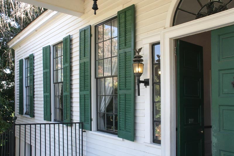 Historical exterior plantation green shutters on a white house.