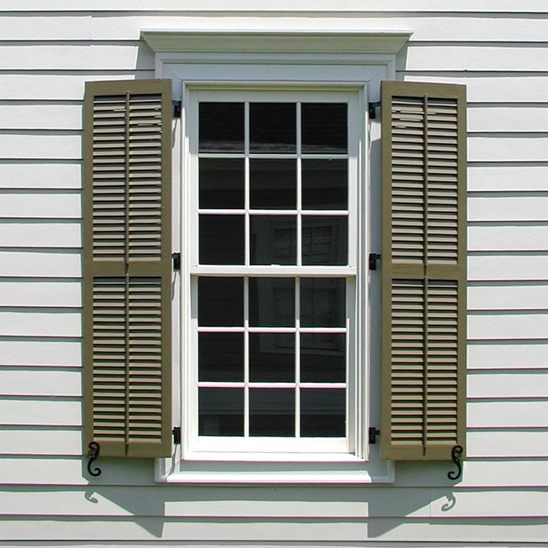 Louvered wood exterior shutters with faux tilt bar.