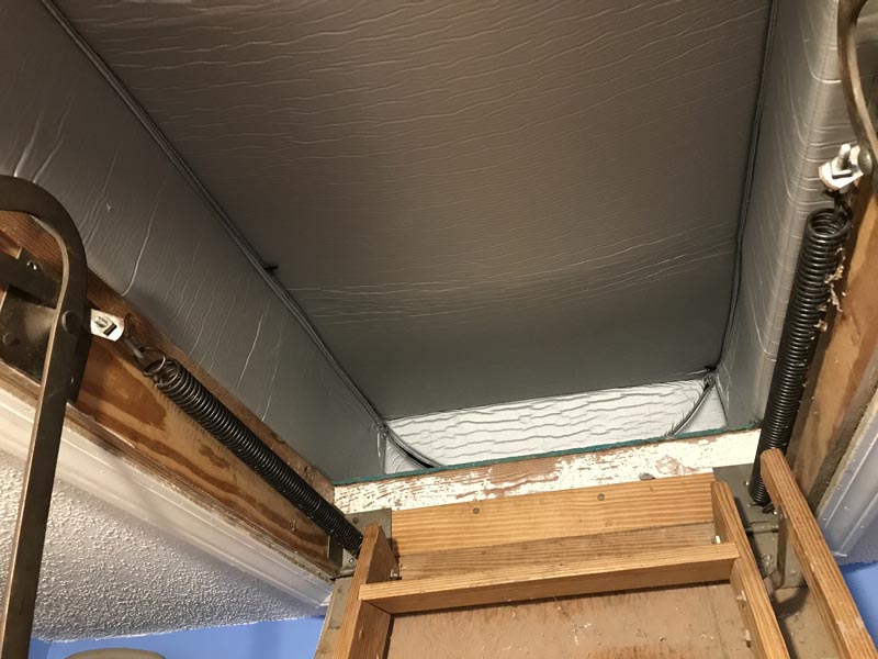 Insulate attic stairs with a tent cover.