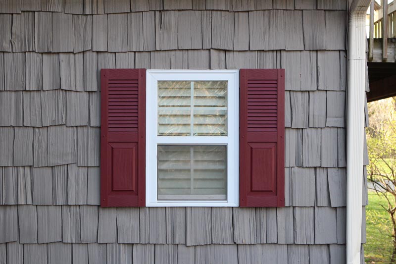 Exterior vinyl shutters combination style installed.
