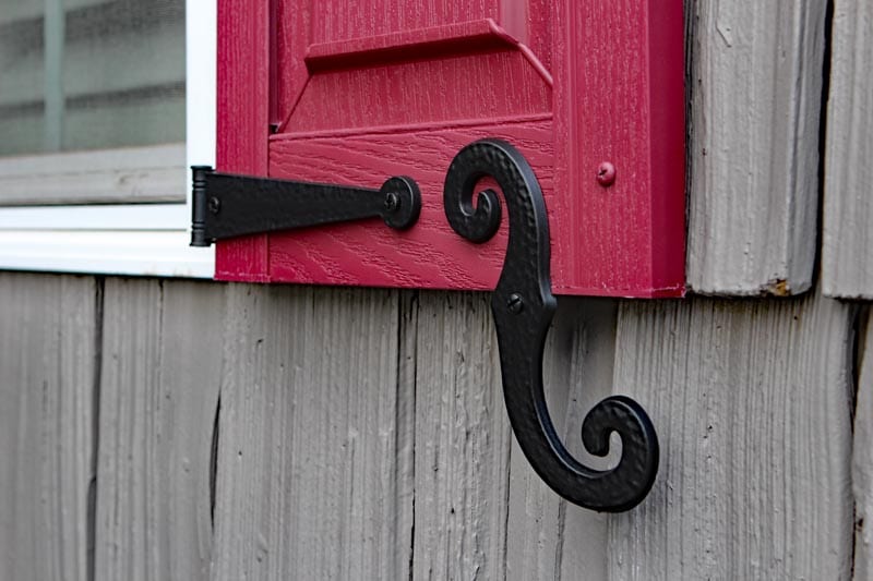 Faux vinyl shutter dogs on window shutters.