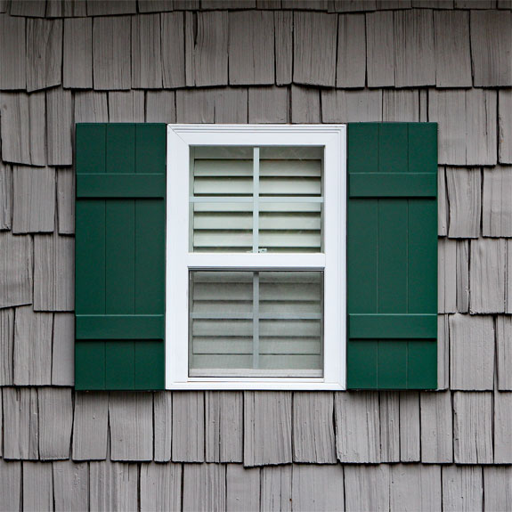 Green composite board and batten shutters installed.