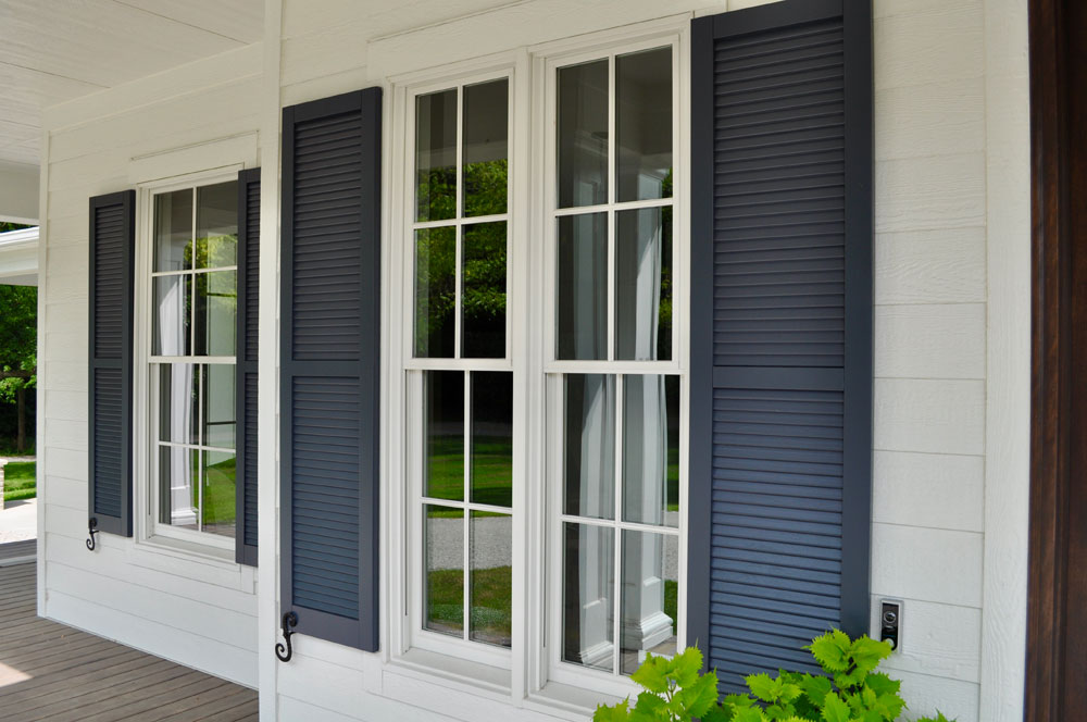 Front porch window shutters painted blue.