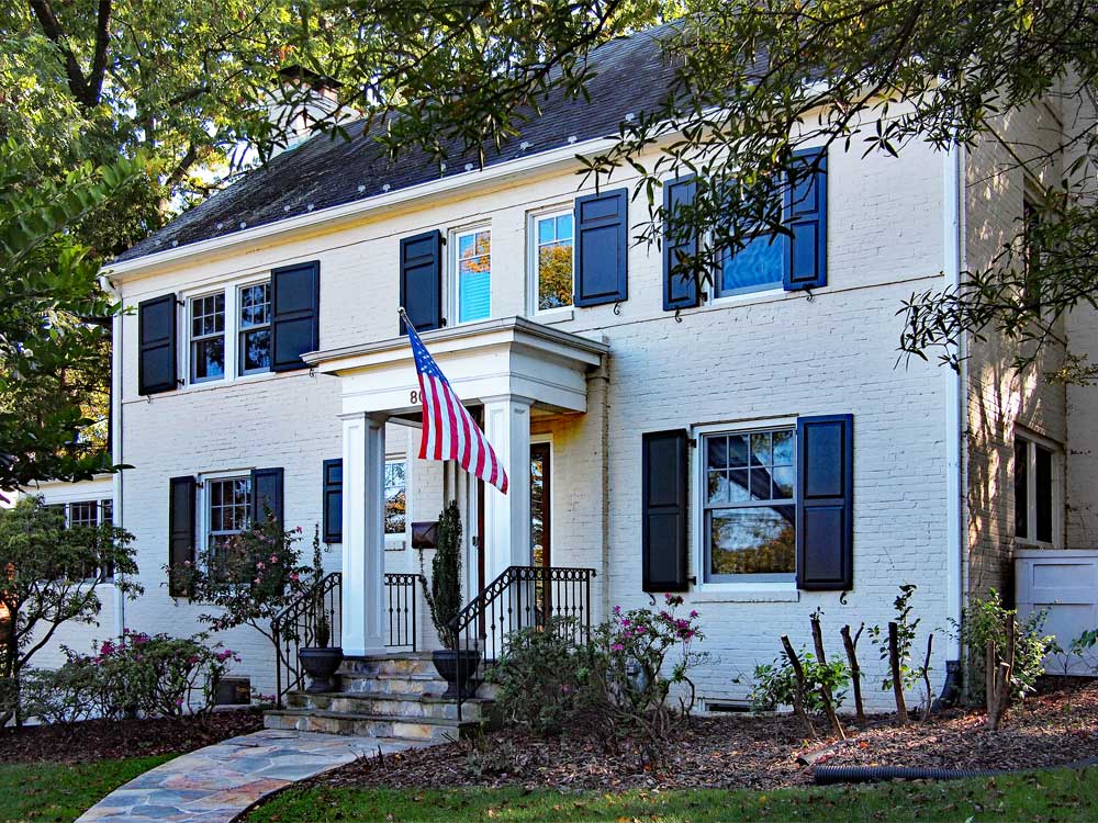 Raised panel composite exterior shutters shown on an American house.