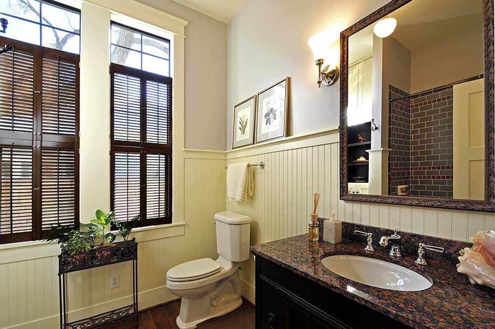 Double tier traditional interior shutters installed on bathroom windows.