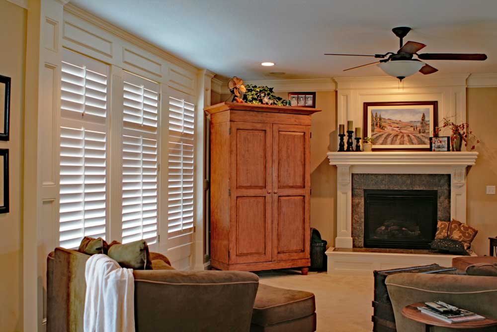 Interior plantation shutters installed on living room windows. 