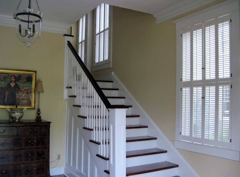 Beautiful traditional shutters with small louvers on interior windows.