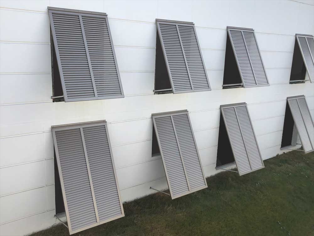 Aluminum hurricane bahama shutters installed on windows.