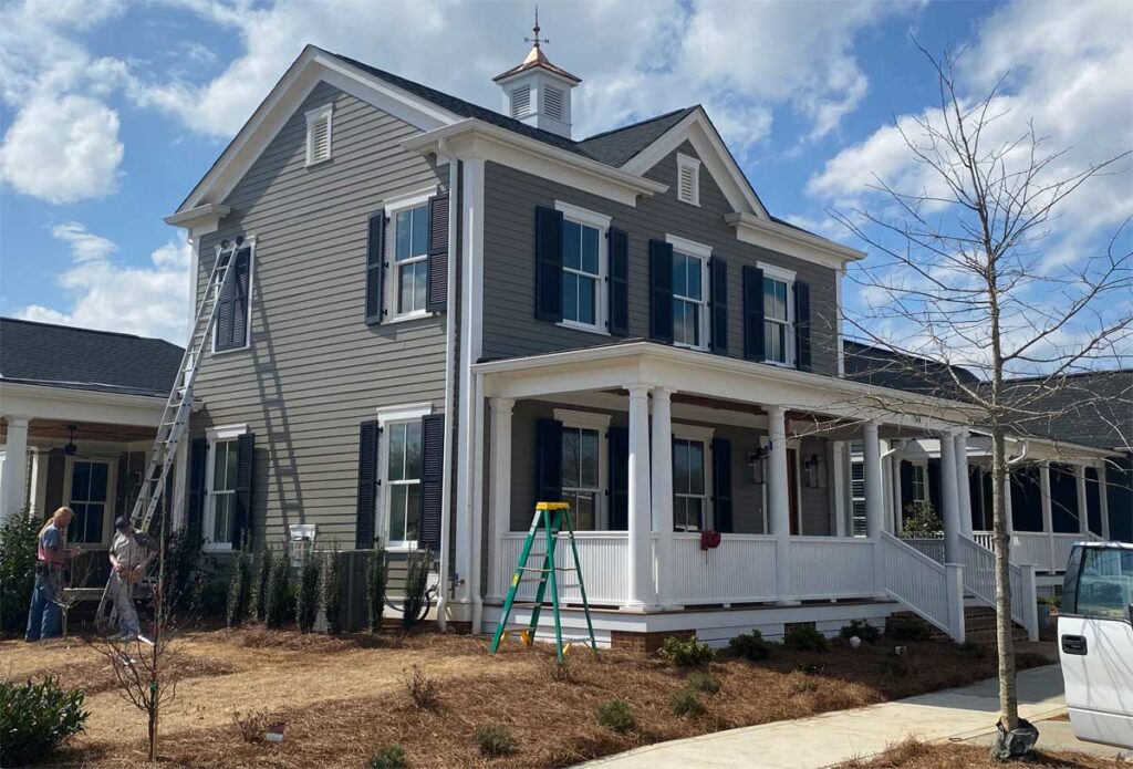 Installing PVC exterior shutters on a traditional house.
