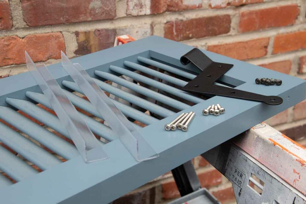 Louvered PVC exterior shutter hardware for installation to the house.