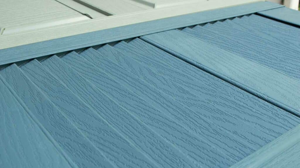 Vinyl shutter surface showing raised wood grain.