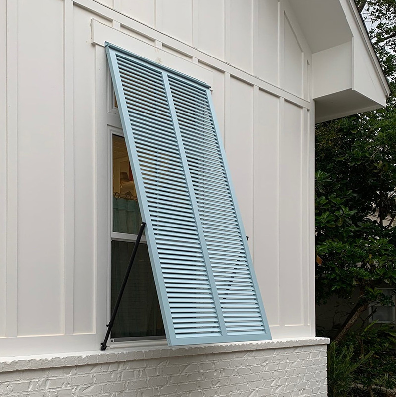 Large blue exterior aluminum hurricne bahama shutter with one sub-stile.