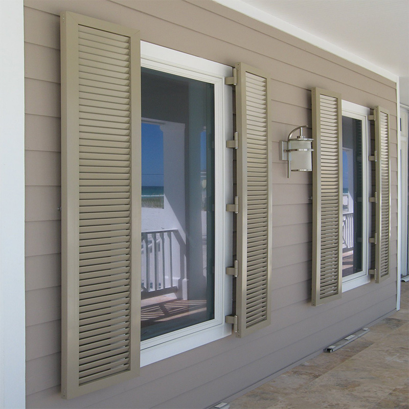 Tan colonial aluminum storm panels installed on tall windows.