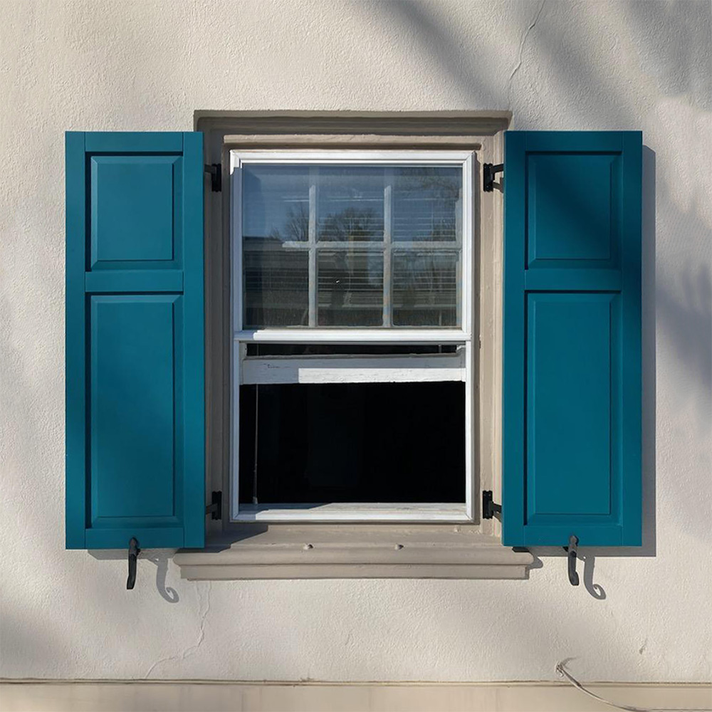 Teal raised panel exterior shutters.