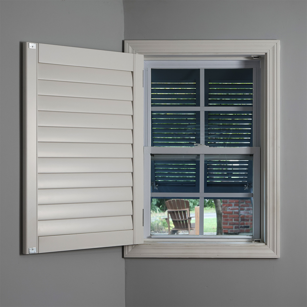 Inside view of an open PVC outdoor window shutter.