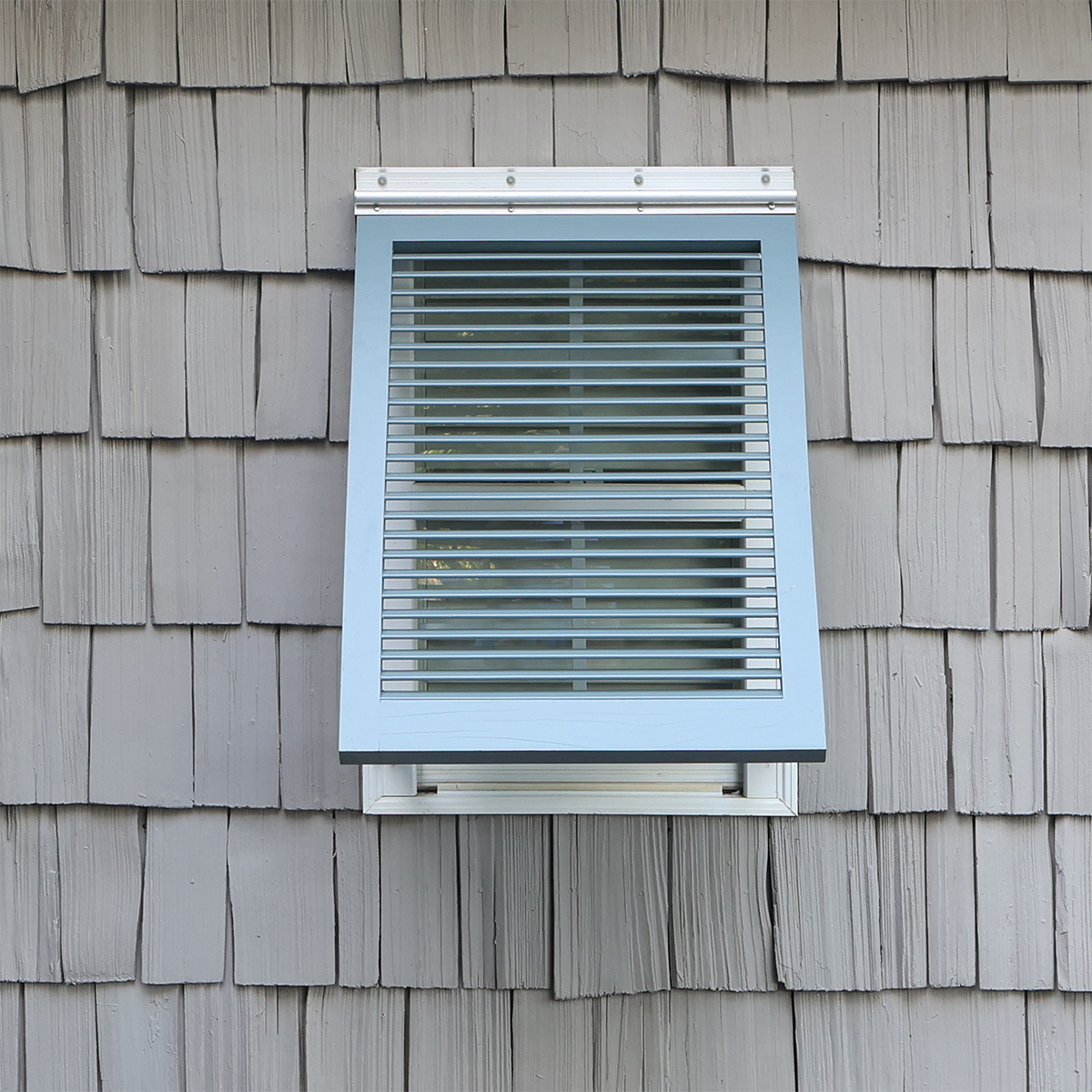 Installed wood Bahama exterior coastal shutter with no sub-stile.